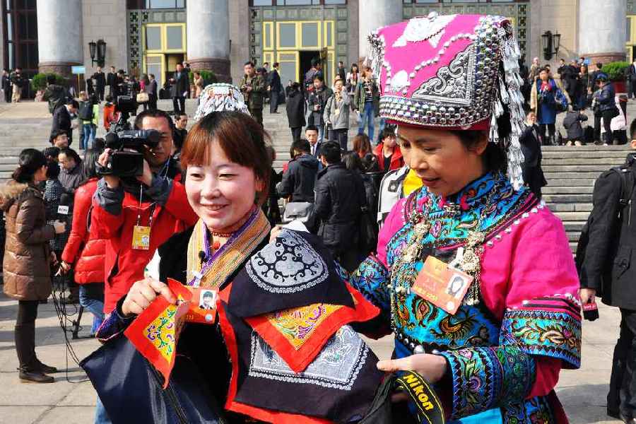 云南代表團的兩位女代表在為記者展示她們帶來的民族特色手工藝品。 人民網(wǎng)記者 馬麗婭 攝