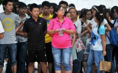 6月7日，雅安天全中學的呂莎莎老師(中)在考場外等待自己的學生出來。